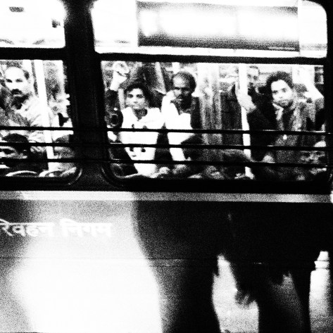 Passengers in a DTC bus try and catch a glimpse of the candle light vigil organised outside Safdarjung Hospital. Thousands of commuters became witness to today’s meet – some got down from their buses to join the vigil. Some joined their hands when their gaze fell on the bed of candles. An old woman took out her hair clip that was shaped like a flower and threw it towards us.