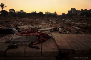 Two people huddle for warmth as the day begins on Tuesday.
