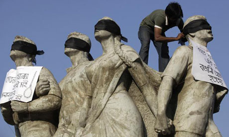 Protest and the past … An activist demands capital punishment for Bangladesh's Jamaat-e-Islami senior leader Abdul Quader Mollah. Photograph: Andrew Biraj/Reuters